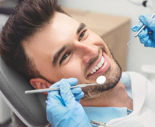 man gets dental check up